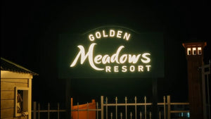 The Golden Meadows Resort illuminated signage at night