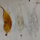 Hand-blown glass leaves in deep amber, pale gold and clear glass, made for the Guwahati feather chandelier