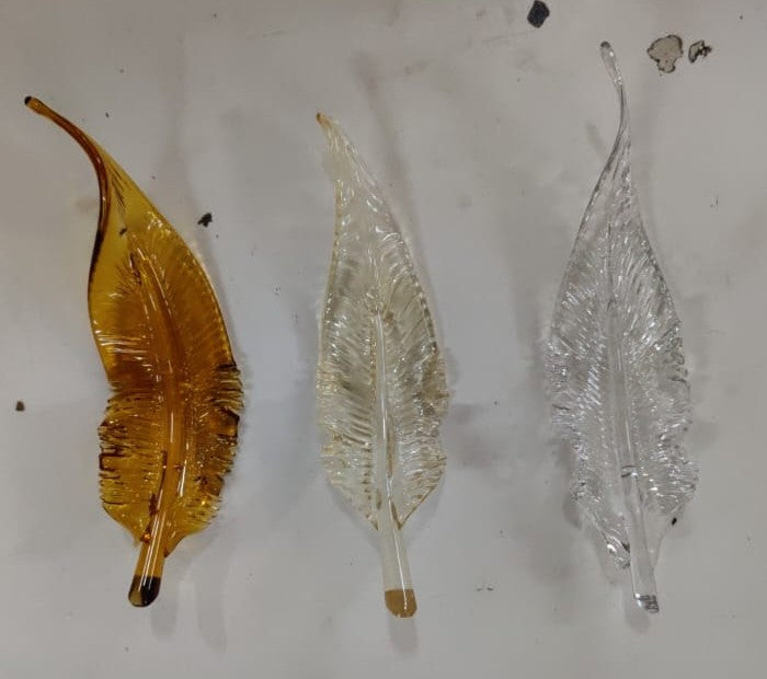 Hand-blown glass leaves in deep amber, pale gold and clear glass, made for the Guwahati feather chandelier