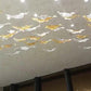 Close view of the glass leaves hung on fine strings below the ceiling