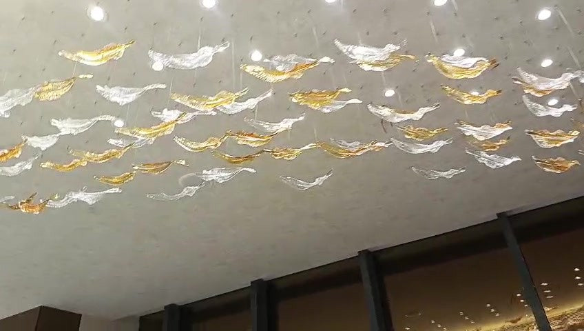 Close view of the glass leaves hung on fine strings below the ceiling